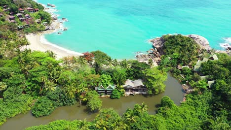 luxurious villas over rocky coastline of tropical island with secret exotic beach and palm trees forest, thailand