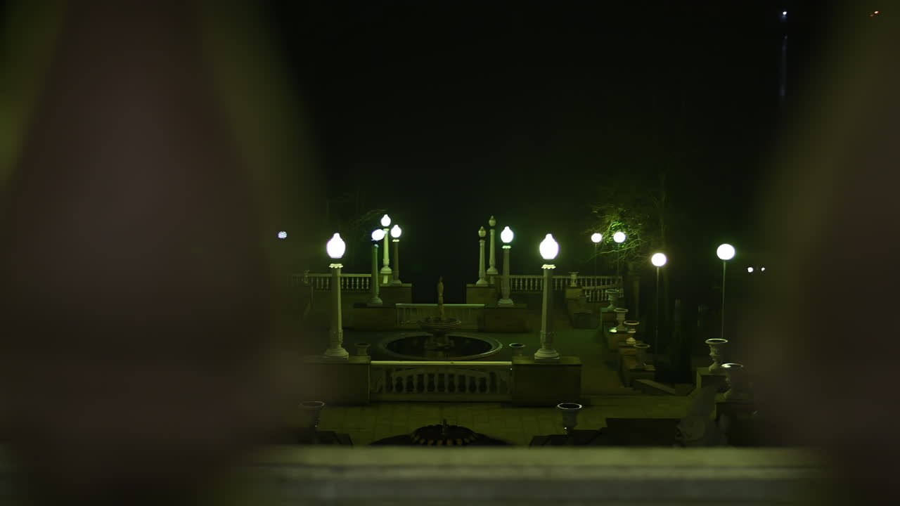 Discover a serene park setting at night, where elegant lamps illuminate the pathways. The peaceful ambiance invites relaxation and reflection in this picturesque location