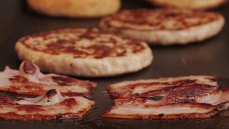 cooking american fat smash burger and bacon slice on grill close-up. chiken or fish cutlet smashing by burger press. the chef in kitchen of the restaurant making cutlets for burgers - smash burger beefsteak. fast and street food concept. high quality 4k footage