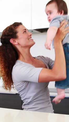 happy mother playing with baby boy