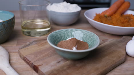 baking ingredients for carrot cake on wooden kitchen table - close up