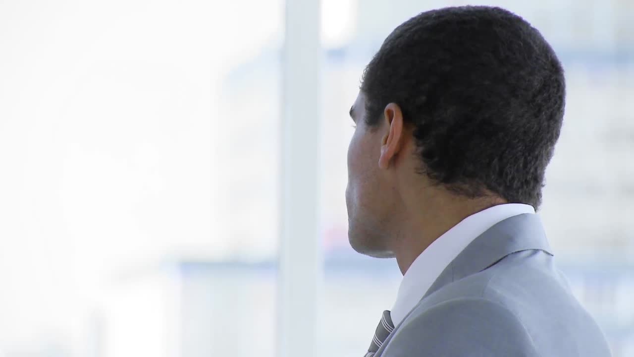 Businessman standing in office smiling at the camera