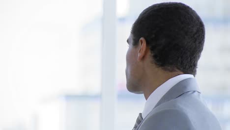 businessman standing in office smiling at the camera