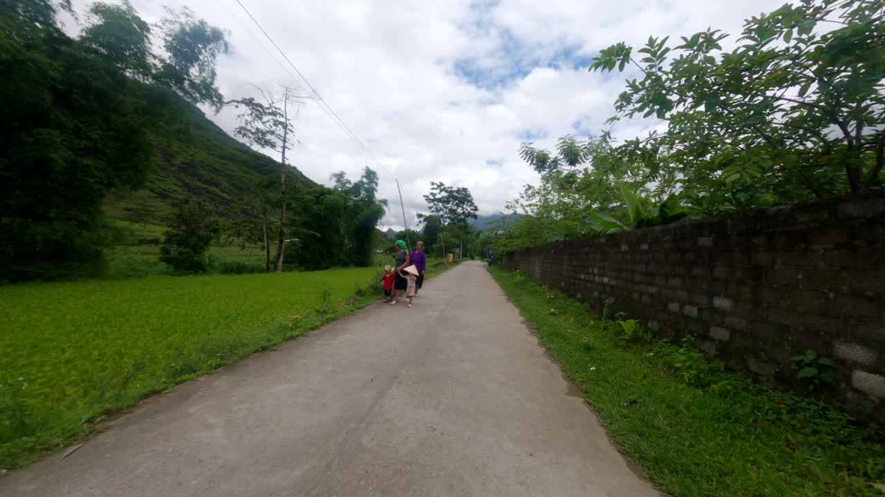 Motorcycle Driving On Street Through Vegetation In Ha Giang Province, Vietnam. wide POV shot