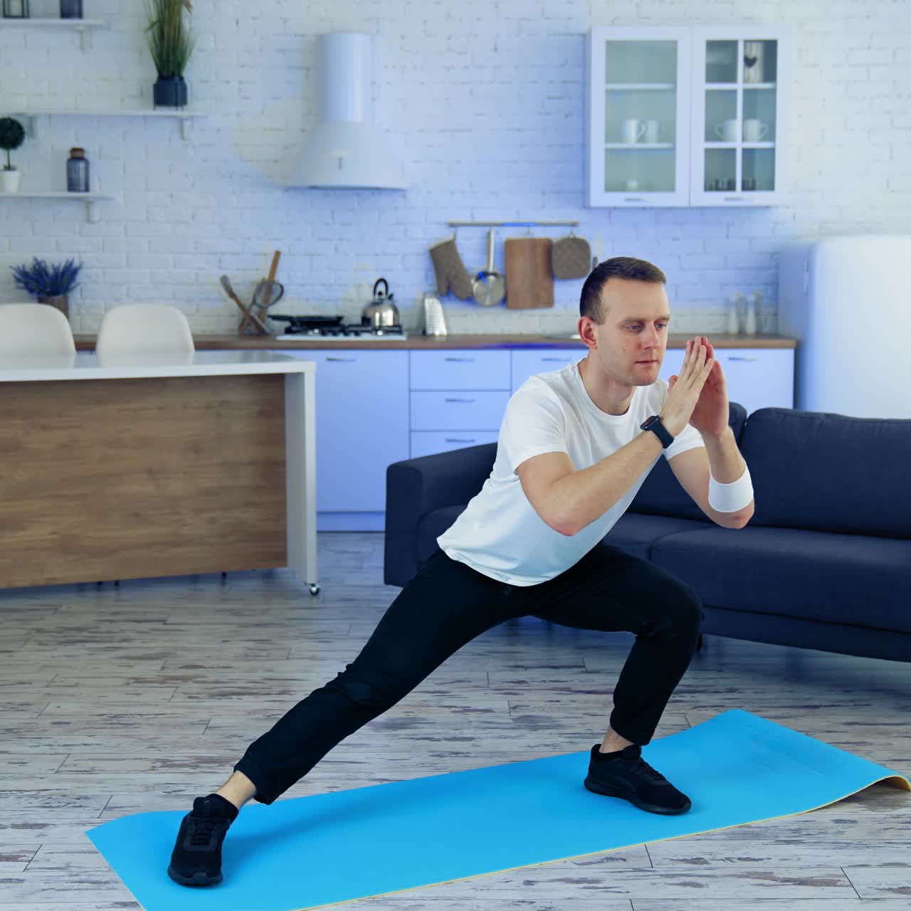 Man on fitness mat at home. Strong athletic fit man doing exercises at home