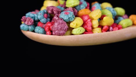vibrant cereal pieces tumble from a spoon against a dark backdrop, highlighting dynamic motion and vivid colors