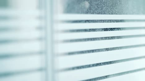 male figure peering through window