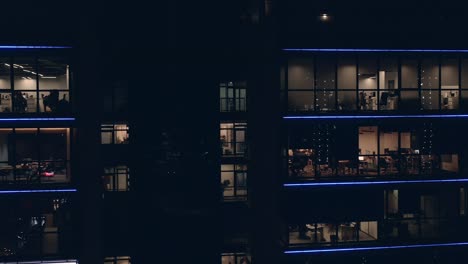 office windows with people in business center at night