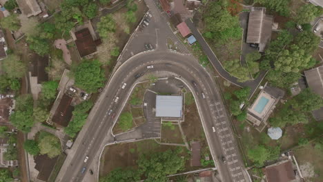 Aerial-top-down-footage-of-a-curved-road-in-Freetown,-Sierra-Leone,-Africa