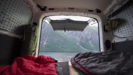 view of a camper van with person inside the portable sleeping bag blanket