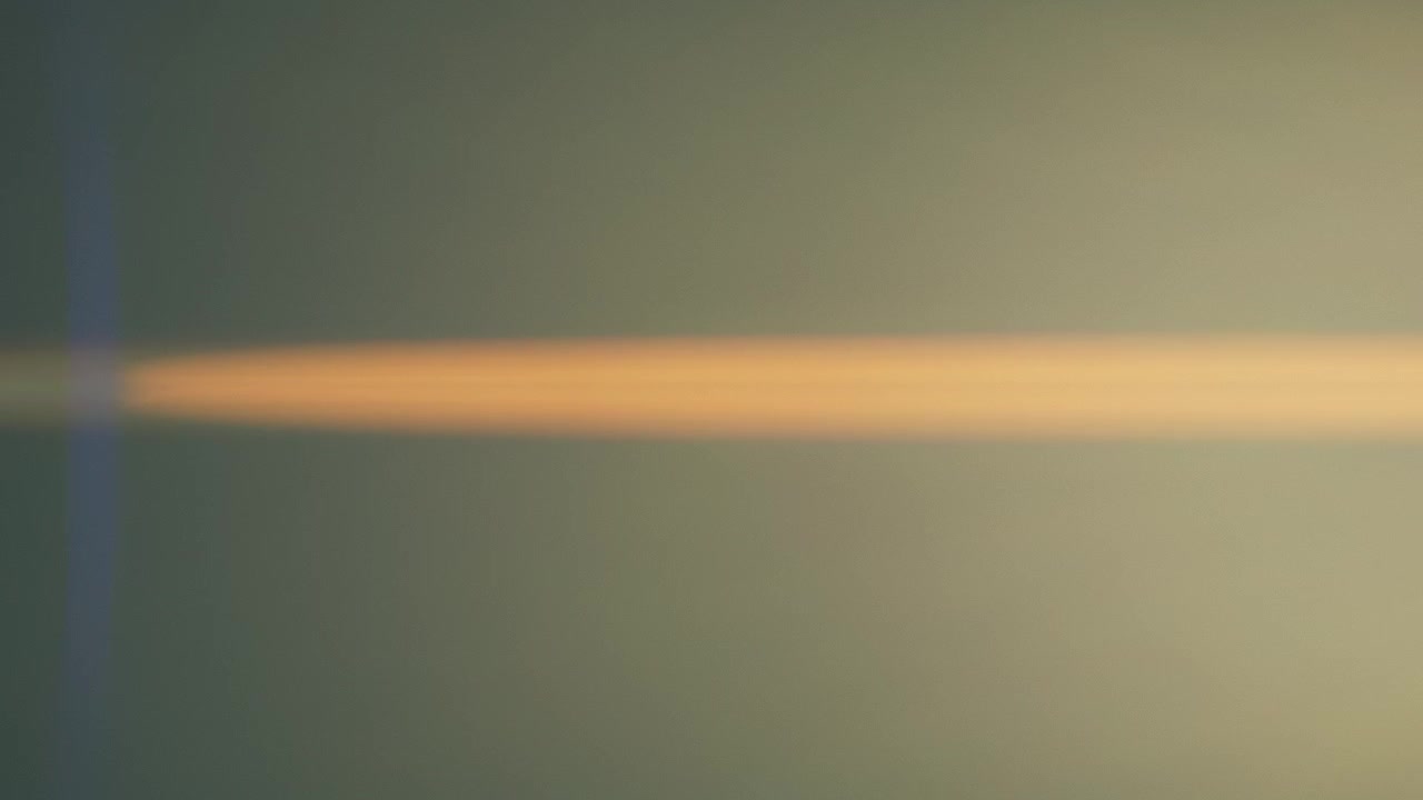 Anamorphic lens flares fading out into dark background