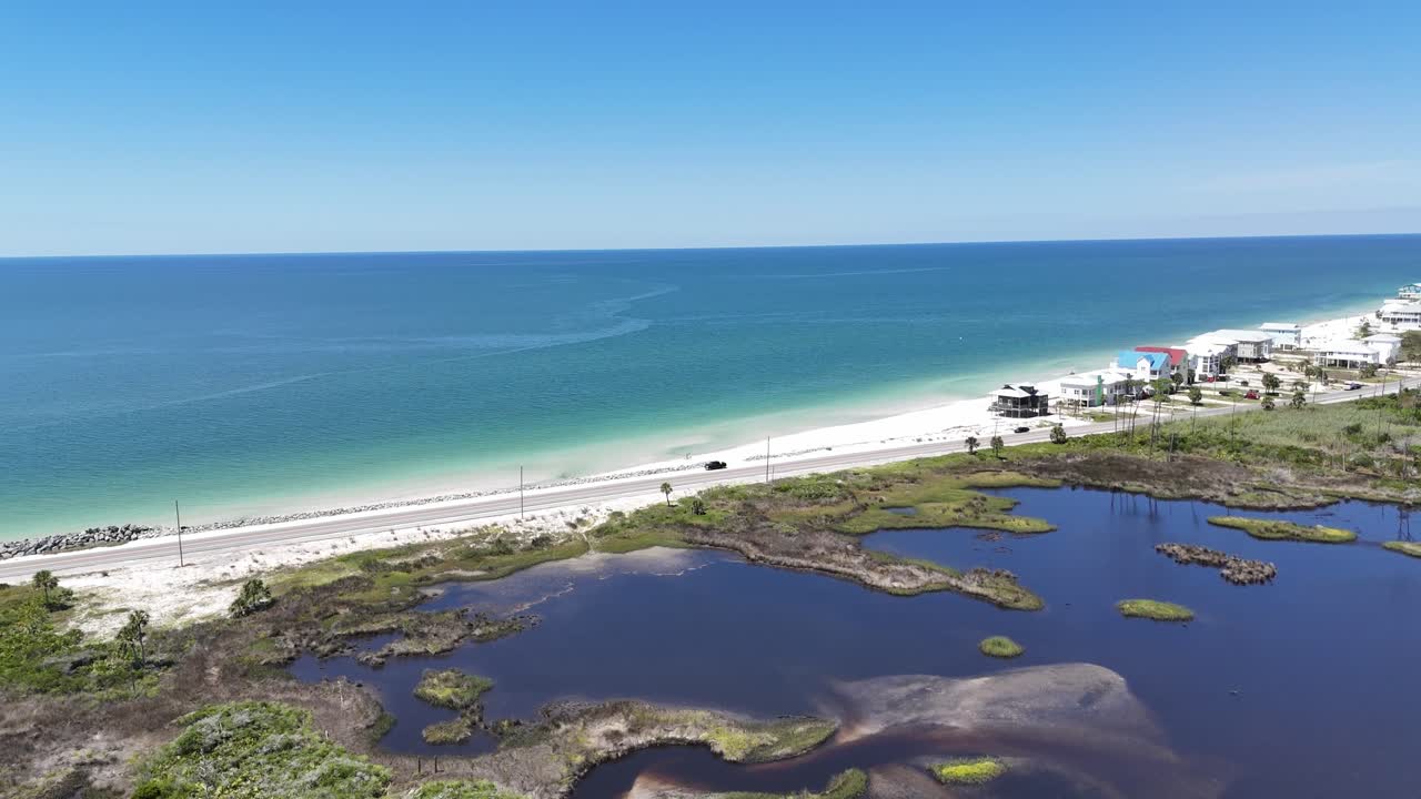 Aerial orbit over coastal wetlands with natural habitat and distant ocean horizon, Cape San Blas, Gulf County, Florida, USA