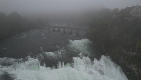 aerial shot in approach the falls of the rhine and approaching the bridge that crosses it