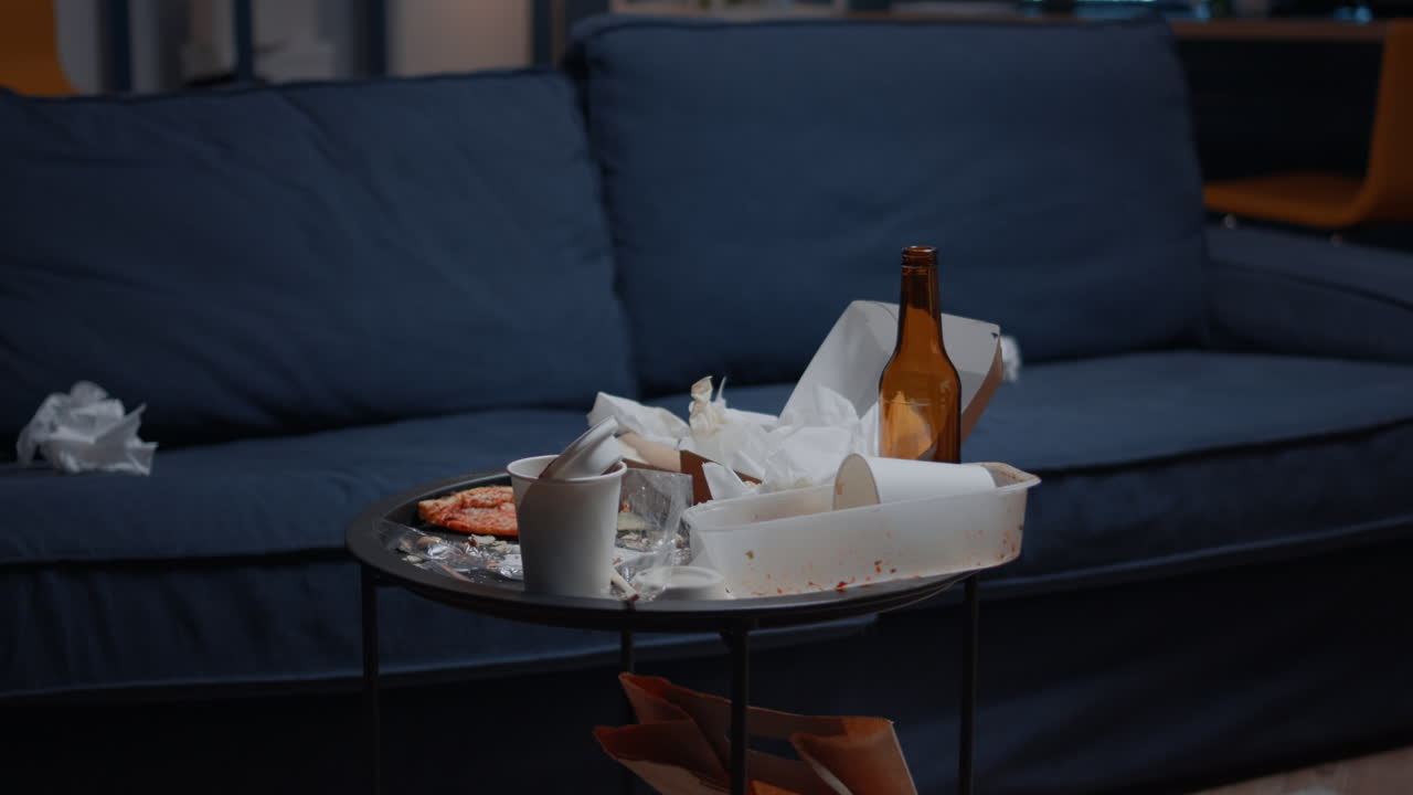 Empty home of depressed person with messy table with leftover on it