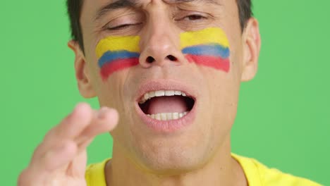 very nervous man supporting colombian team during a difficult match