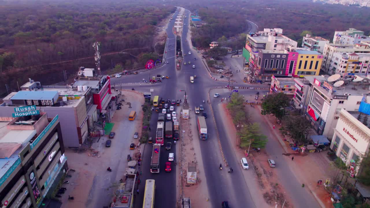 Traffic jam on suchitra circle with Russh Super Speciality Hospital and trees at suchitra, hyderabad, telangana, india. day time, push in, drone shot, 4k.