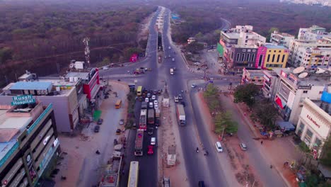 traffic jam on suchitra circle with russh super speciality hospital and trees at suchitra, hyderabad, telangana, india. day time, push in, drone shot, 4k.