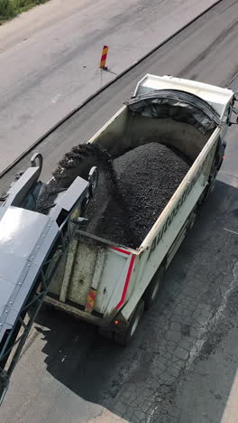 machinery work construction road. industrial dumper trucks working on highway construction site. vertical video