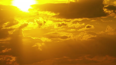 Bright,-golden-sunset-cloudscape---dramatic-zoomed-in-time-lapse