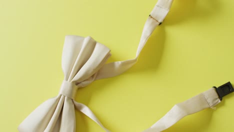 video of yellow bow tie lying on yellow background