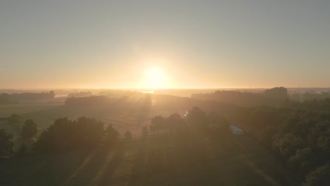 sunrise over a misty countryside landscape