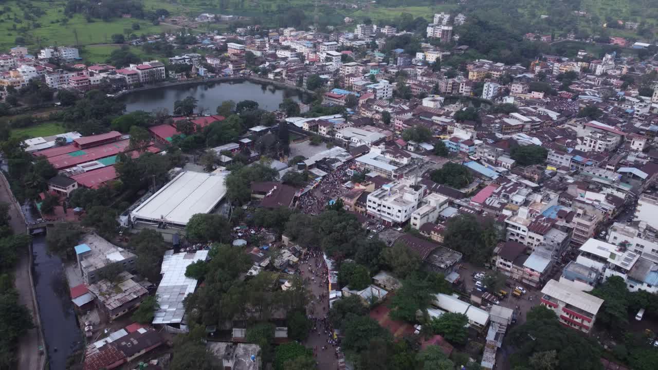 Drone shot of crowd of Hindu devotees walking towards Trimbakeshwar Temple dedicated to Lord Shiva at the foothills of the Brahmagiri and Gangadwar mountains, Trimbak Town, Nashik, Maharashtra, India