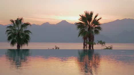a reflective swimming pool boundary and an evening sea scenery