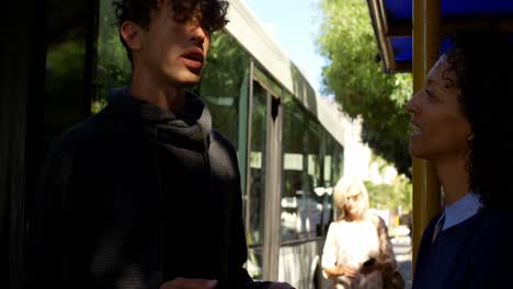 couple interacting with each other at bus stop 4k