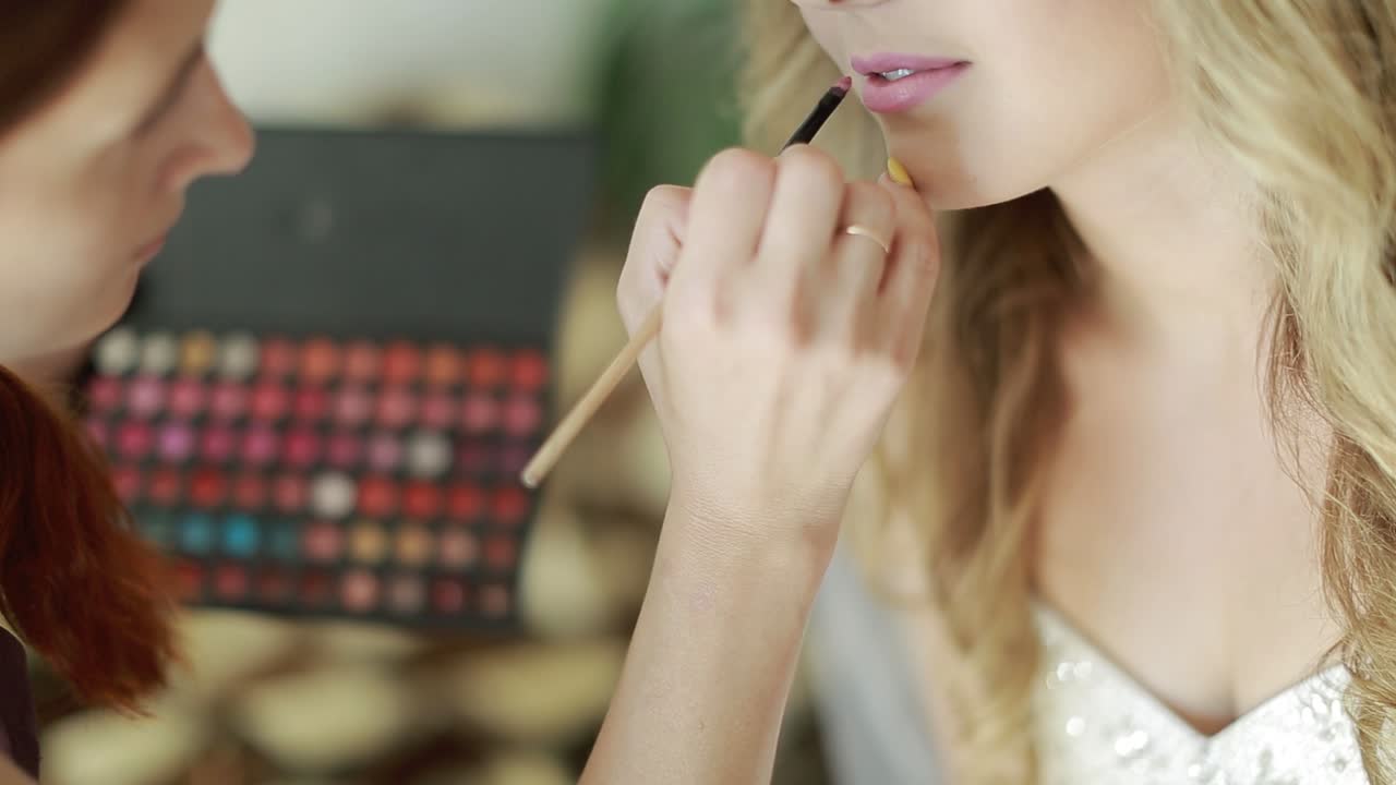 Bridal Morning Of A Cute Lady. Wedding makeup artist making a make up for bride