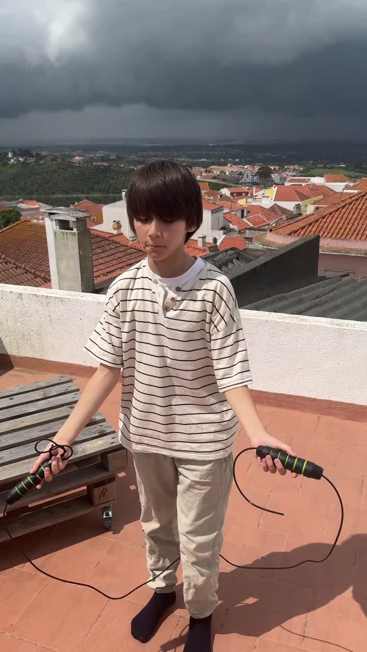 Boy Jumping Rope on Rooftop
