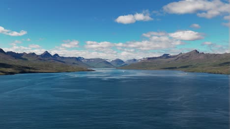 Fishing-Boats-Sailing-In-The-Faskrudsfjordur,-Fjord-At-Daytime-In-East-Iceland