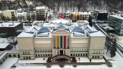 drone shot of vytautas the great war museum in cold snowy winter in kaunas, lithuania