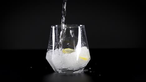 pouring soda water with lemon