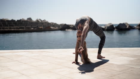 Backbend-yoga-stretches-harbour-Barcelona-Spain