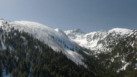 Drone-shot-of-snowy-peak-and-ski-slope-in-Malyovitsa-in-Bulgaria