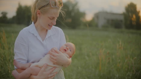 woman holding her son in field