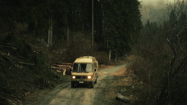 Van driving through a mountain forest