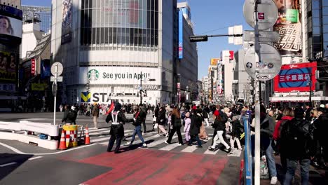 pedestrians crossing a busy urban intersection