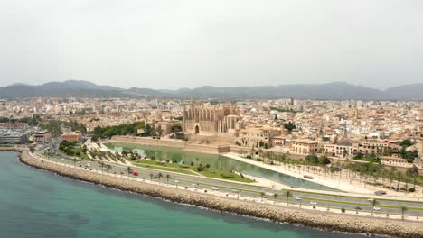 car traffic around medieval cathedral in historical palma city center