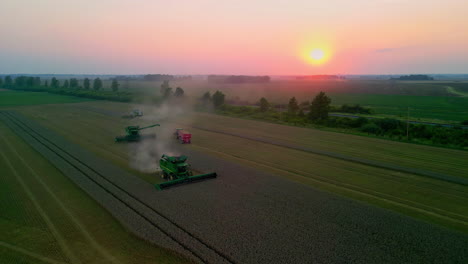 Combine-harvesters-gathering-wheat-crops-at-dusk---aerial-view
