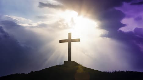 a wooden cross silhouette against a cloudy sky with a bright light behind it.