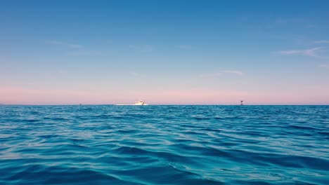 low-angle view of speedboat traveling on blue ocean sea waters