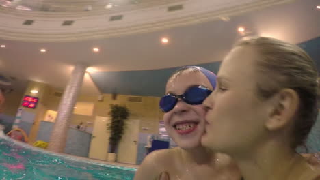 boy having good time with mom in water park