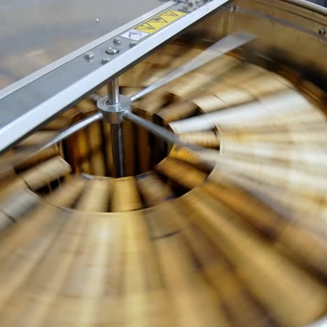 getting honey from honeycomb. manual centrifuge device, spinning the honey from cells