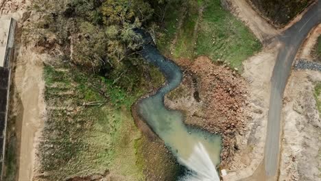 Aerial-footage-zooming-out-of-the-water-outlet-and-spillway-at-Lake-Nillahcootie,-Victoria,-Australia,-June-2019