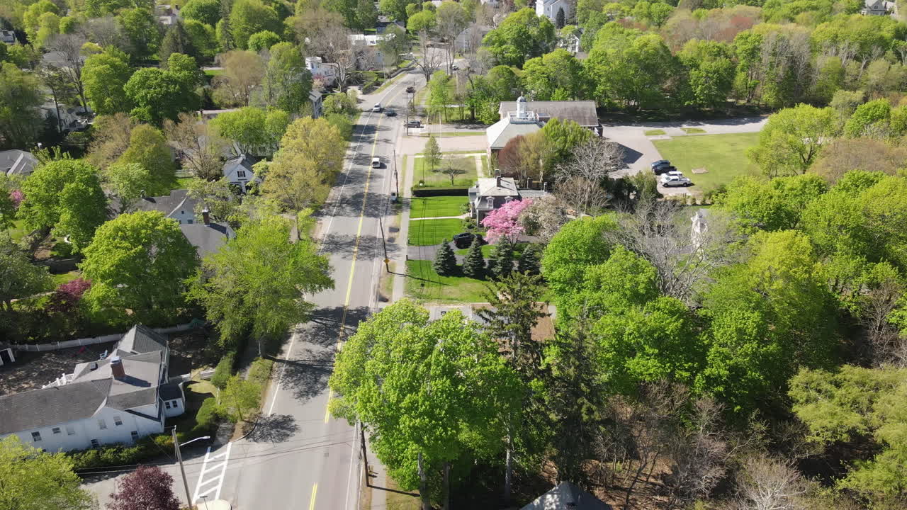 Aerial static footage of tree lined street with traffic, spring foliage, Hingham MA