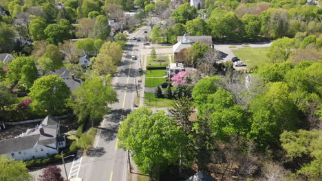 aerial static footage of tree lined street with traffic, spring foliage, hingham ma