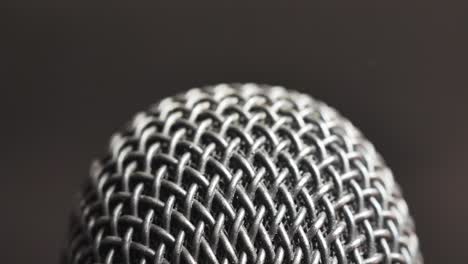 extreme closeup of old dirty stereo microphone head, spinning