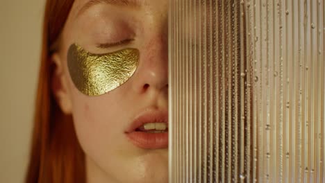 woman with gold eye patches and glass