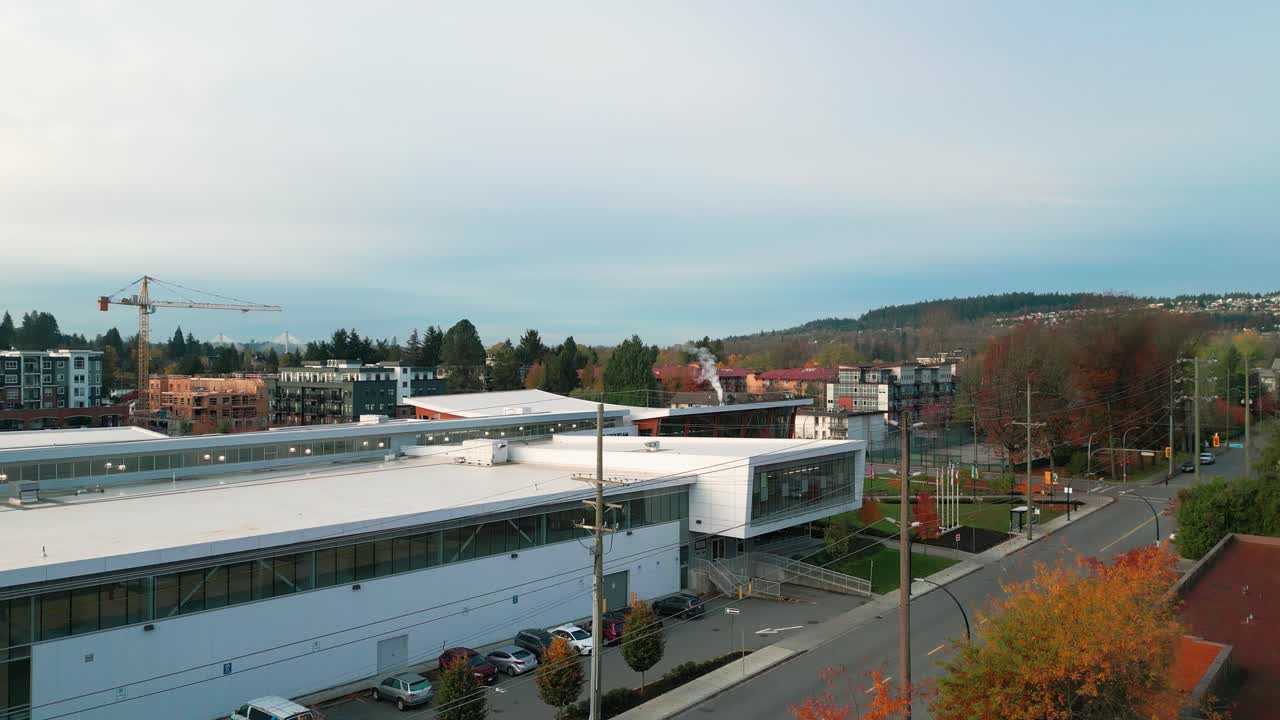 an aerial shot of the port coquitlam community center with the coquitlam mountains in the background